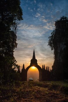 Man at gates to temple at sunset - image #344621 gratis